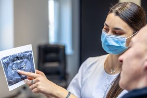 a dentist is showing dental x-ray