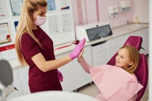 a little girl is getting dental treatment